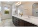 Well-lit bathroom featuring double sinks, ample countertop space, and a large mirror at 5649 E Desert Forest Trl, Cave Creek, AZ 85331