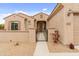 Charming stucco home featuring a gated front porch, tile roof, and desert landscaping at 5649 E Desert Forest Trl, Cave Creek, AZ 85331