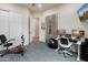 Home gym with exercise equipment, desk, and TV, creates a versatile workout space at 5649 E Desert Forest Trl, Cave Creek, AZ 85331