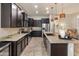 Modern kitchen featuring granite countertops, stainless steel appliances, and dark cabinets at 5649 E Desert Forest Trl, Cave Creek, AZ 85331