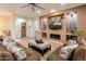 Cozy living room with a fireplace, TV, comfortable seating, and warm lighting at 5649 E Desert Forest Trl, Cave Creek, AZ 85331