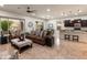 Bright and open living room showcasing modern decor, an open kitchen, and patio access at 5649 E Desert Forest Trl, Cave Creek, AZ 85331