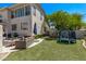 Spacious backyard with artificial turf, outdoor seating, grill, play area, perfect for outdoor activities and relaxation at 6026 E Sonoran Trl, Scottsdale, AZ 85266