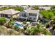 A stunning backyard features a sparkling pool, putting green, play area, multiple seating areas, and lush landscaping at 6026 E Sonoran Trl, Scottsdale, AZ 85266