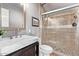 Bathroom featuring a glass enclosed tile shower and vanity with a modern sink and dark wood base at 6026 E Sonoran Trl, Scottsdale, AZ 85266
