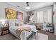 Cozy bedroom featuring eclectic art, toys, shutters, and a rocking chair, blending comfort with creativity at 6026 E Sonoran Trl, Scottsdale, AZ 85266