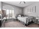Charming bedroom with a wrought iron bed frame, arched window with plantation shutters, and gray walls at 6026 E Sonoran Trl, Scottsdale, AZ 85266