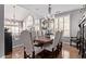 Formal dining room with seating for eight boasts large windows with shutters and decorative chandelier at 6026 E Sonoran Trl, Scottsdale, AZ 85266