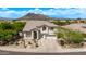Charming two-story home boasts a desert landscape, tile roof, mountain views, and attached two car garage at 6026 E Sonoran Trl, Scottsdale, AZ 85266