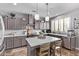 Well-appointed kitchen features stainless steel appliances, a large island, and gray cabinetry at 6026 E Sonoran Trl, Scottsdale, AZ 85266