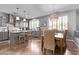 Modern kitchen with stainless steel appliances, island with bar seating, and adjacent dining area at 6026 E Sonoran Trl, Scottsdale, AZ 85266