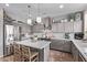 Well-appointed kitchen features stainless steel appliances, a large island, and gray cabinetry at 6026 E Sonoran Trl, Scottsdale, AZ 85266