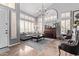 Bright living room features high ceilings, large windows with shutters, a chandelier, a piano, and comfortable seating at 6026 E Sonoran Trl, Scottsdale, AZ 85266
