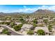 Picturesque view of a desert neighborhood with mountain backdrop and mature trees at 6026 E Sonoran Trl, Scottsdale, AZ 85266