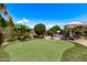 Beautiful backyard features putting green, lush landscaping, lounge chairs, and a pool for outdoor enjoyment at 6026 E Sonoran Trl, Scottsdale, AZ 85266