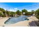 Beautiful pool with waterfall feature, surrounded by lush landscaping and comfortable lounge chairs for relaxation at 6026 E Sonoran Trl, Scottsdale, AZ 85266