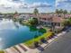 Aerial view showcases a waterfront property with lush landscaping and a private dock on a lake at 633 W Aster Ct, Chandler, AZ 85248