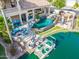 Aerial view of the backyard of a waterfront home with pool, firepit, boat dock, and outdoor kitchen at 633 W Aster Ct, Chandler, AZ 85248
