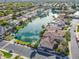Aerial view of a lakeside community with lush landscaping, waterfront homes, and private docks at 633 W Aster Ct, Chandler, AZ 85248