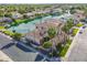 Aerial view of a waterfront house with mature landscaping, tile roof, and a community lake at 633 W Aster Ct, Chandler, AZ 85248