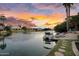 Luxury lakeside living with boat dock, lounge area, and stunning sunset views from the backyard at 633 W Aster Ct, Chandler, AZ 85248