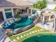 Inviting backyard pool area with waterfall feature, outdoor kitchen, and lovely waterfront view at 633 W Aster Ct, Chandler, AZ 85248