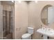 The bathroom features a tiled walk-in shower with a bench, modern fixtures, and a pedestal sink at 633 W Aster Ct, Chandler, AZ 85248