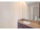 Bathroom with an oak cabinet and tan tile backsplash mirror, and lighting at 633 W Aster Ct, Chandler, AZ 85248