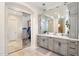 Elegant bathroom with a double vanity with a marble countertop and closet with mirrors at 633 W Aster Ct, Chandler, AZ 85248
