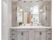 Stylish bathroom with a double vanity featuring a marble countertop and modern lighting at 633 W Aster Ct, Chandler, AZ 85248