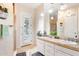 Bright bathroom featuring a double vanity with tile countertop, a shower, and a door to the outside at 633 W Aster Ct, Chandler, AZ 85248