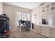 This bedroom provides ample space with a workstation, shelving, and an abundance of natural light at 633 W Aster Ct, Chandler, AZ 85248