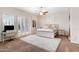 Cozy bedroom features carpet, plantation shutters, a ceiling fan and a desk, perfect for working from home at 633 W Aster Ct, Chandler, AZ 85248
