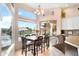 Bright dining area with large windows overlooking the water and custom chandelier at 633 W Aster Ct, Chandler, AZ 85248