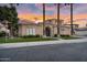 Beautiful stucco home with mature palm trees, manicured lawn and wrought iron entry gate at 633 W Aster Ct, Chandler, AZ 85248