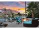 An outdoor fire pit with seating and boat dock on the waterfront creates a relaxing lakeside retreat at 633 W Aster Ct, Chandler, AZ 85248