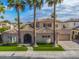 Exterior features a tile roof, arched entry, lush landscaping, and a three-car garage at 633 W Aster Ct, Chandler, AZ 85248