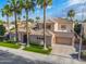Elegant two-story home featuring a tile roof, a three-car garage, and well-manicured landscaping at 633 W Aster Ct, Chandler, AZ 85248