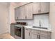 Clean, organized laundry room features modern appliances, shaker cabinets and quartz countertops at 633 W Aster Ct, Chandler, AZ 85248