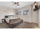 Spacious bedroom features two windows, a ceiling fan and a seating area at 633 W Aster Ct, Chandler, AZ 85248