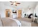 Spacious primary bedroom with multiple ceiling fans and areas for relaxing or working at 633 W Aster Ct, Chandler, AZ 85248