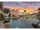 Backyard paradise with pool, lake, outdoor kitchen, and basketball hoop perfect for entertaining at 633 W Aster Ct, Chandler, AZ 85248