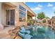 Stunning backyard pool and spa with rock features and slide and patio area at 633 W Aster Ct, Chandler, AZ 85248