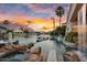 Waterfront pool features a waterfall, diving board, and stunning sunset views at 633 W Aster Ct, Chandler, AZ 85248