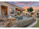 Backyard pool with waterfall feature, rock accents, and basketball hoop, perfect for outdoor fun at 633 W Aster Ct, Chandler, AZ 85248
