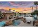 This backyard features a gorgeous pool and spa and a lake view under a colorful sunset at 633 W Aster Ct, Chandler, AZ 85248