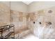An elegant shower with natural stone tiling, dual shower heads, and a built-in bench at 633 W Aster Ct, Chandler, AZ 85248