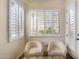 Inviting sitting area with plush chairs and plantation shutters offering a serene retreat at 633 W Aster Ct, Chandler, AZ 85248
