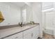 Bright bathroom featuring a single sink vanity with ample storage and view of separate toilet and shower at 670 S Beebe St, Gilbert, AZ 85296