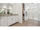 Bright bathroom featuring a walk-in shower with marble tile and double sink vanity with ample storage at 670 S Beebe St, Gilbert, AZ 85296